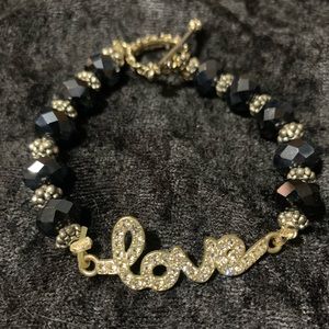 Love beaded bracelet. Measures about 8 inches in length.